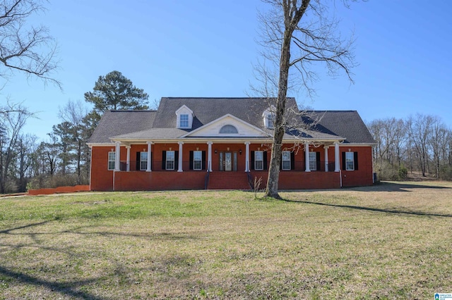 view of front facade with covered porch and a front lawn