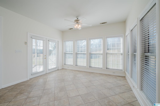 unfurnished sunroom featuring a ceiling fan, french doors, and visible vents