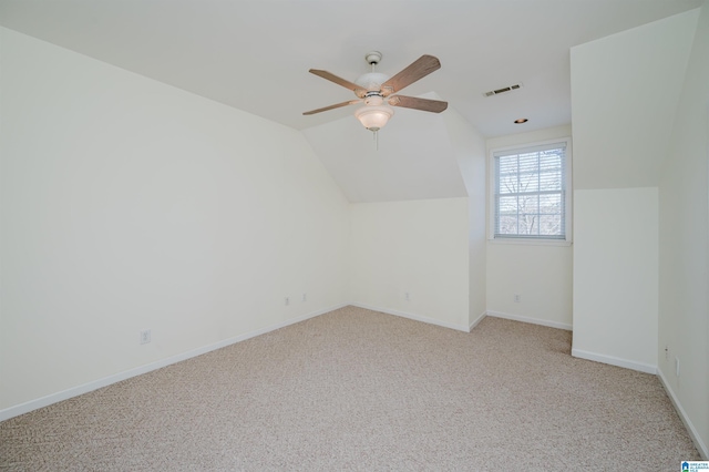 bonus room featuring lofted ceiling, ceiling fan, visible vents, baseboards, and carpet