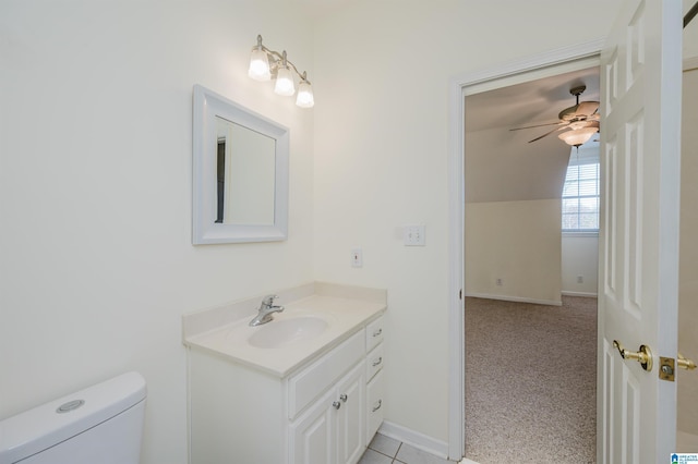 half bath featuring toilet, ceiling fan, baseboards, and vanity