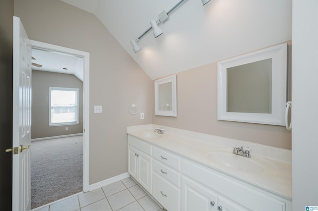 bathroom featuring lofted ceiling, double vanity, tile patterned flooring, and a sink