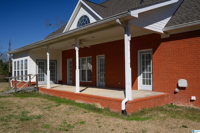 back of house with a patio, french doors, a shingled roof, and brick siding