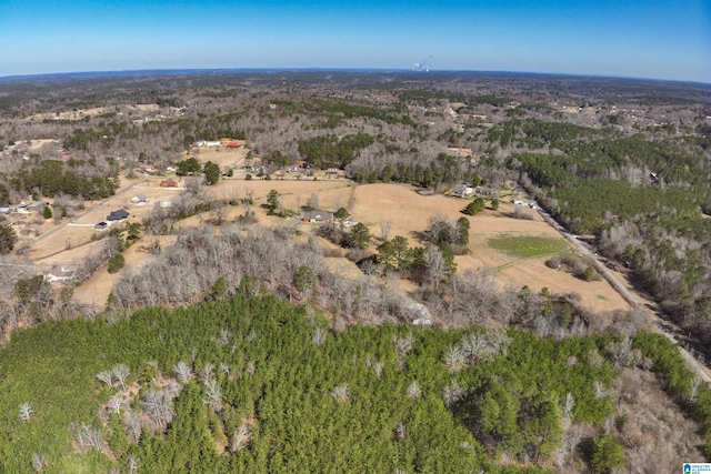 birds eye view of property featuring a view of trees