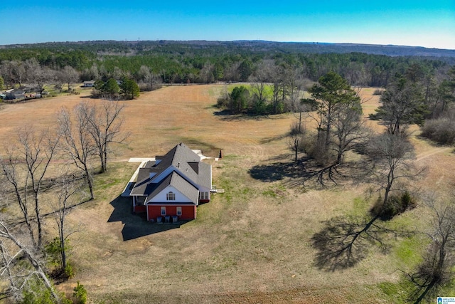 bird's eye view featuring a wooded view and a rural view