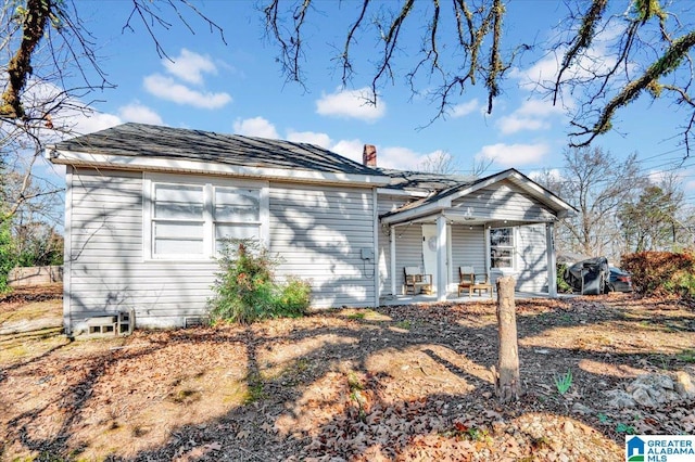 view of front of property featuring a porch and a chimney