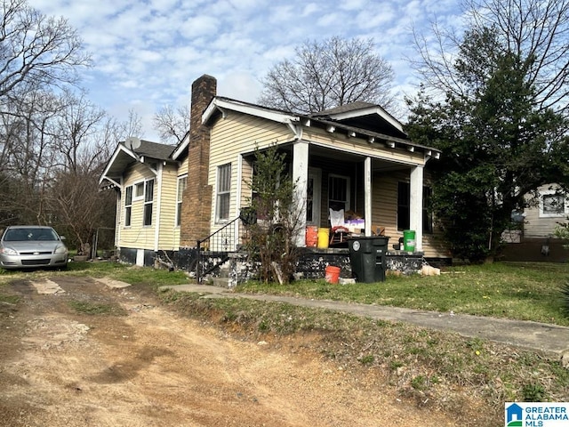 view of front of property with covered porch and a chimney