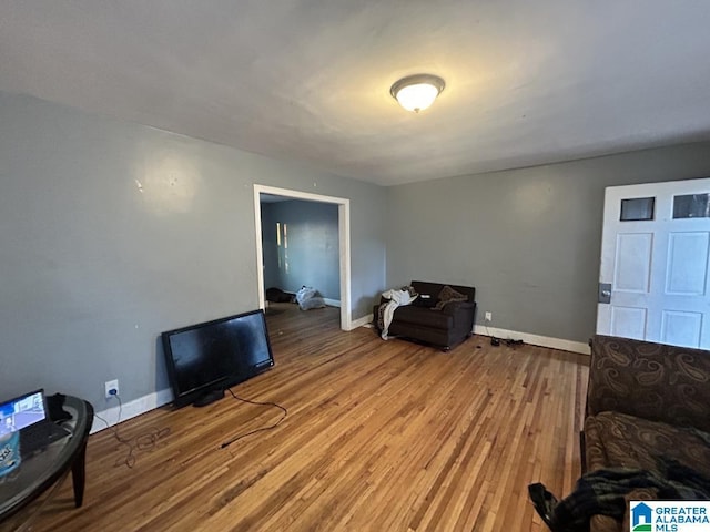 living area featuring wood finished floors and baseboards