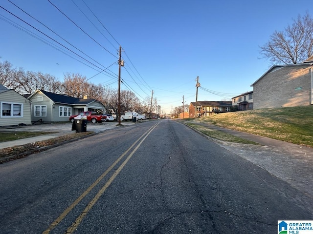 view of street featuring a residential view, curbs, and sidewalks