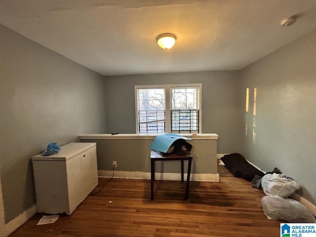 office with dark wood-style floors and baseboards