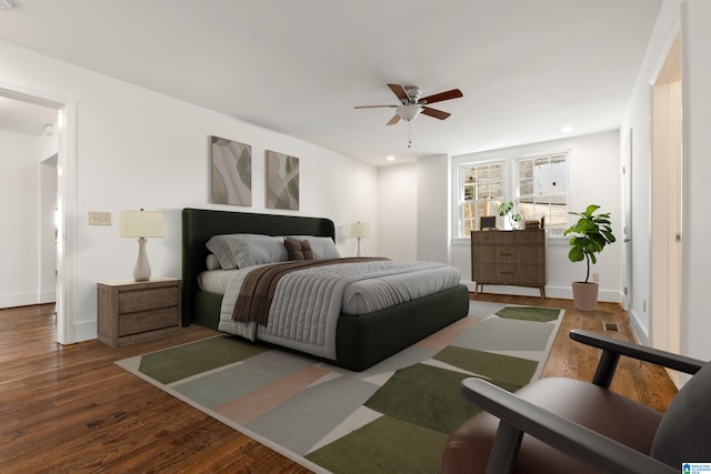 bedroom with baseboards, wood finished floors, a ceiling fan, and recessed lighting
