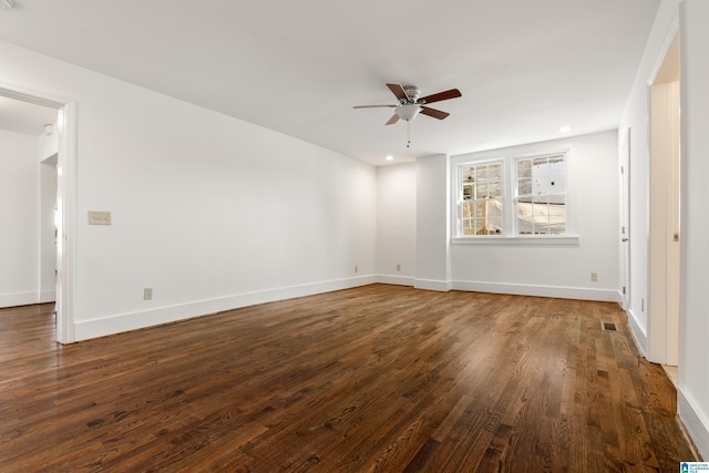 spare room featuring baseboards, visible vents, a ceiling fan, dark wood-type flooring, and recessed lighting