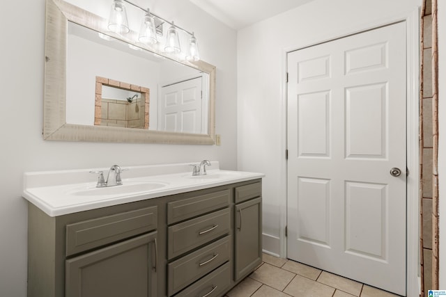 full bathroom with double vanity, tile patterned flooring, and a sink