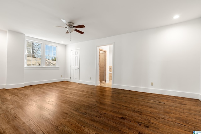 unfurnished bedroom with recessed lighting, a ceiling fan, ensuite bath, wood finished floors, and baseboards