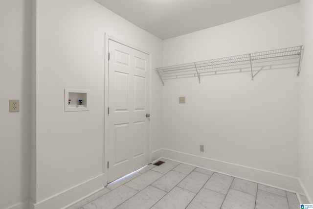 washroom with laundry area, hookup for a washing machine, and baseboards