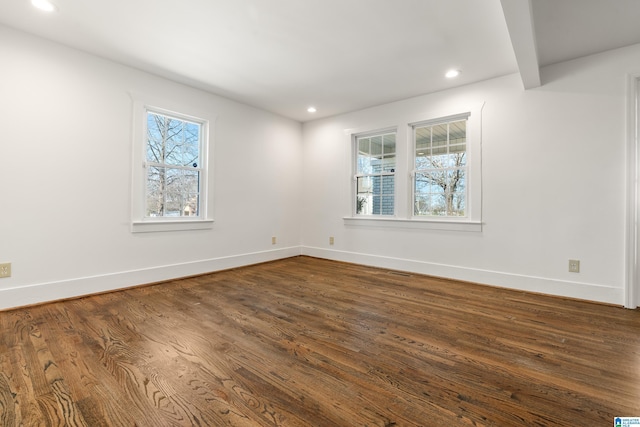 empty room featuring dark wood-style floors, baseboards, and recessed lighting