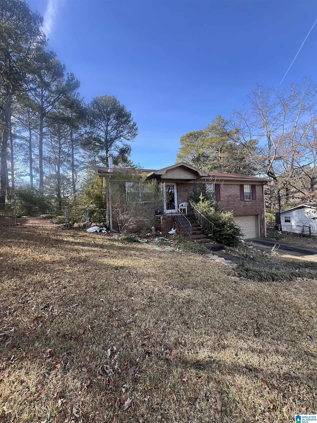 view of front of home featuring a garage and brick siding