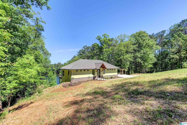 4928 County Road 804, Wedowee, AL 36278 - view of front facade featuring a standing seam roof, metal roof, and stucco siding