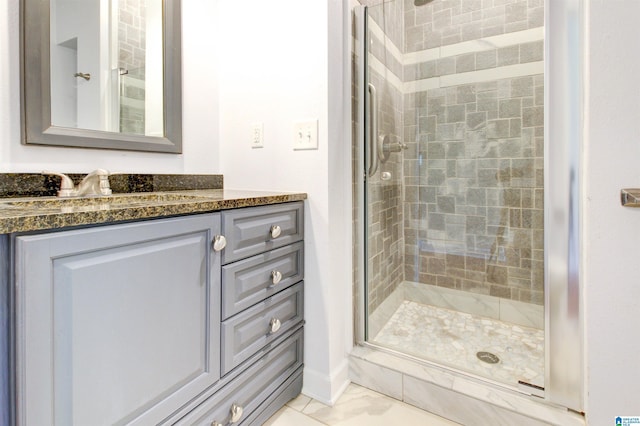 full bathroom with a stall shower, marble finish floor, and vanity