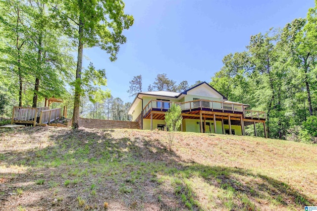 back of house featuring a wooden deck