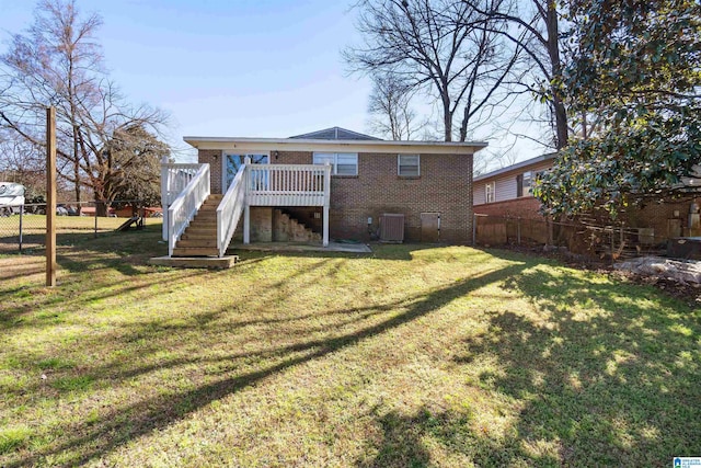 back of house with stairs, fence, a deck, and brick siding