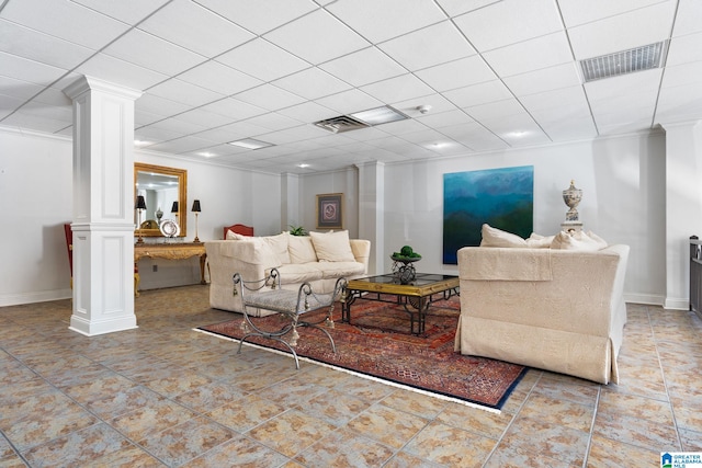 tiled living room with ornamental molding, a drop ceiling, visible vents, and ornate columns