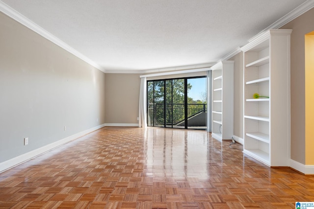 spare room featuring built in features, crown molding, a textured ceiling, and baseboards