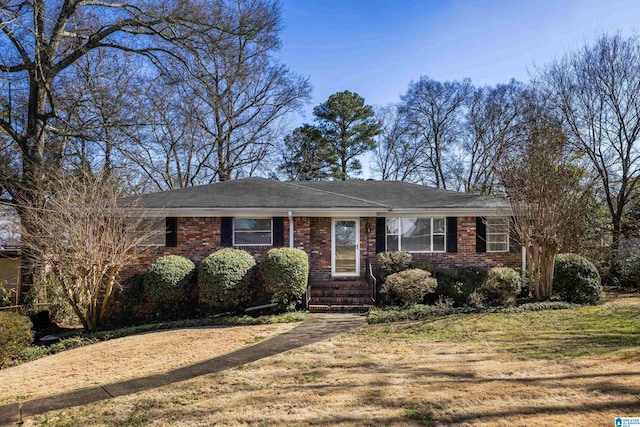 ranch-style house featuring brick siding