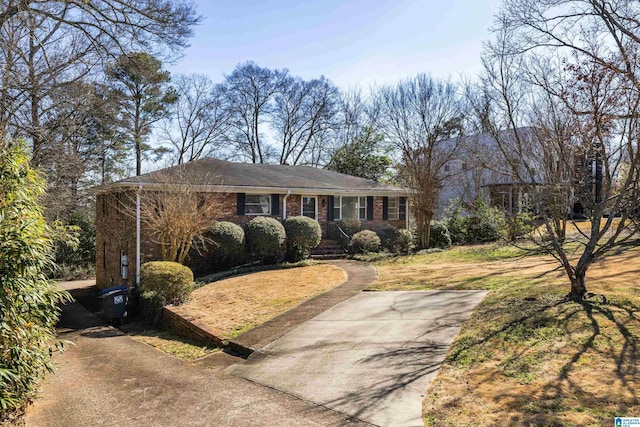 view of front facade with a front yard and brick siding