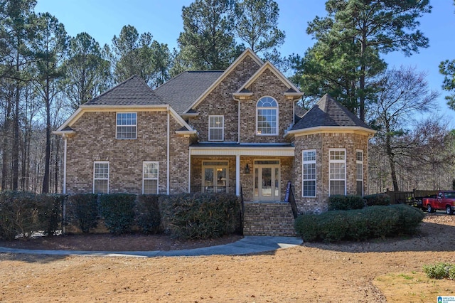 traditional home with brick siding and a porch