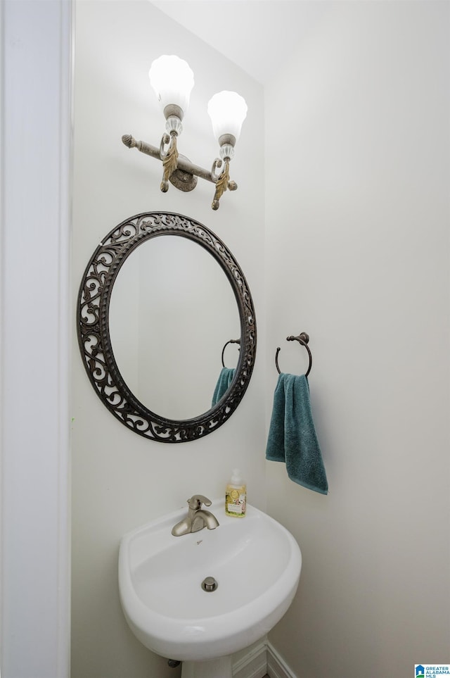 bathroom with a chandelier and a sink