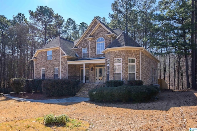 traditional-style house with brick siding and a shingled roof