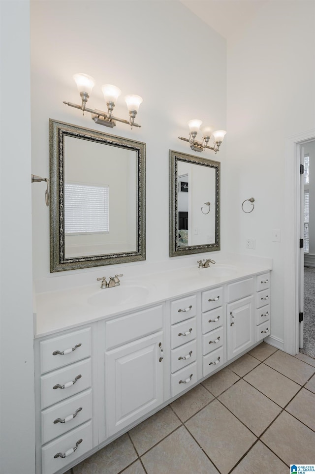 bathroom featuring tile patterned floors, a sink, and double vanity