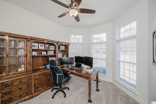 office area with a ceiling fan, carpet flooring, and baseboards