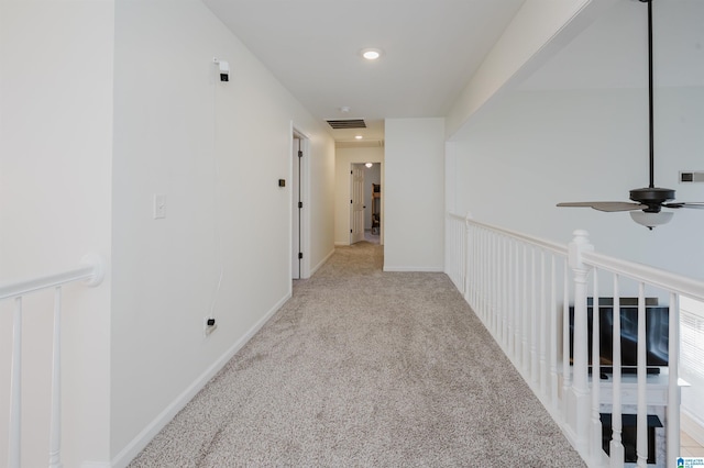 hallway featuring carpet floors, recessed lighting, visible vents, and baseboards