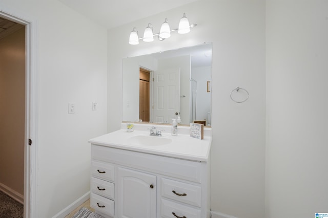 bathroom with baseboards and vanity