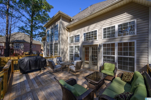 wooden deck featuring outdoor lounge area, area for grilling, and french doors