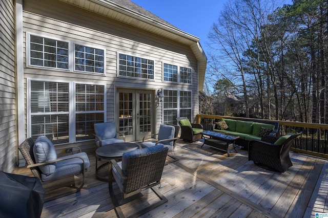 wooden terrace with french doors and an outdoor living space