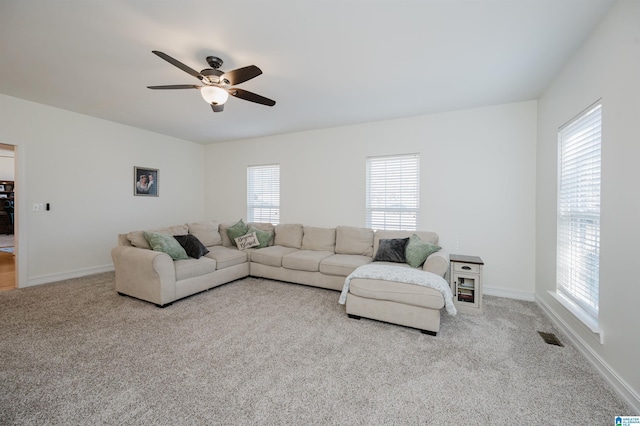 carpeted living room with visible vents, ceiling fan, and baseboards