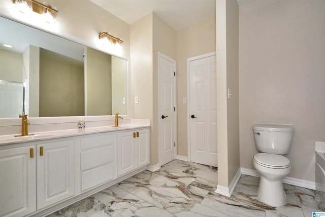 full bathroom featuring double vanity, baseboards, toilet, marble finish floor, and a sink