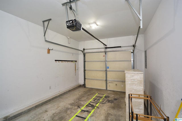 garage featuring baseboards and a garage door opener