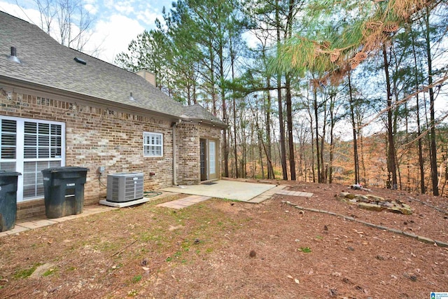 view of yard featuring central AC and a patio area