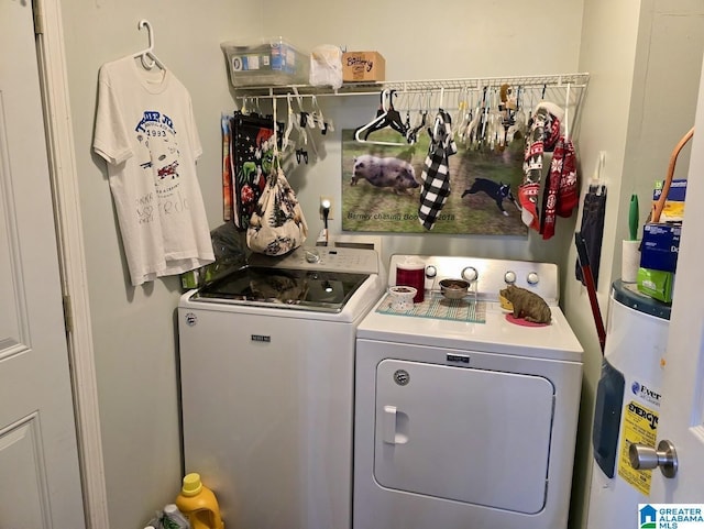 washroom featuring laundry area, electric water heater, and separate washer and dryer