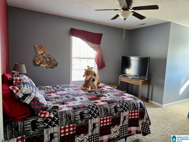 bedroom featuring carpet floors, visible vents, ceiling fan, a textured ceiling, and baseboards