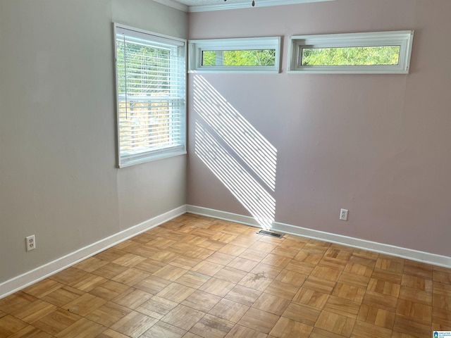 spare room with visible vents and baseboards