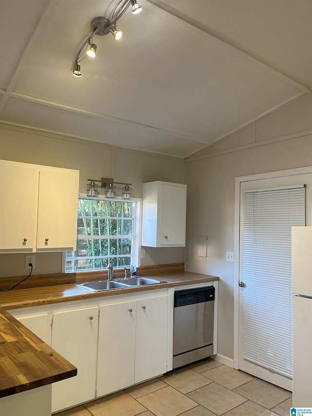 kitchen with stainless steel dishwasher, a sink, freestanding refrigerator, and white cabinets