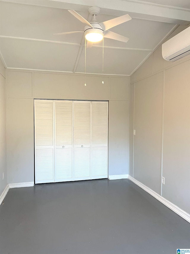 unfurnished bedroom featuring lofted ceiling, a closet, a wall unit AC, and concrete floors