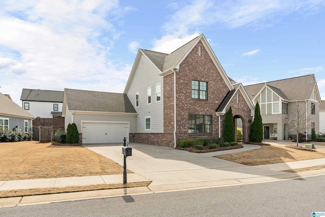 view of front of home with a garage, fence, concrete driveway, and brick siding