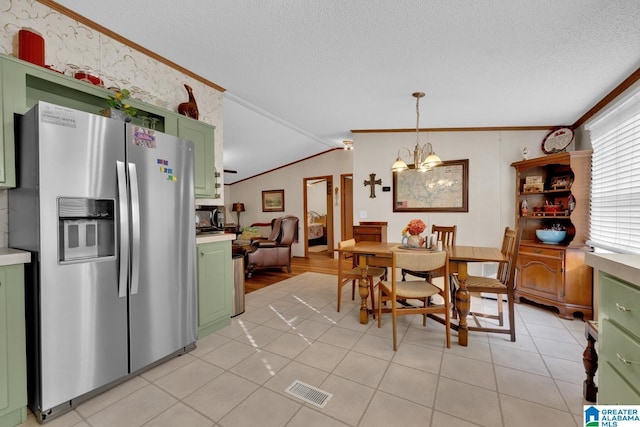 dining area featuring visible vents, ornamental molding, vaulted ceiling, and a textured ceiling