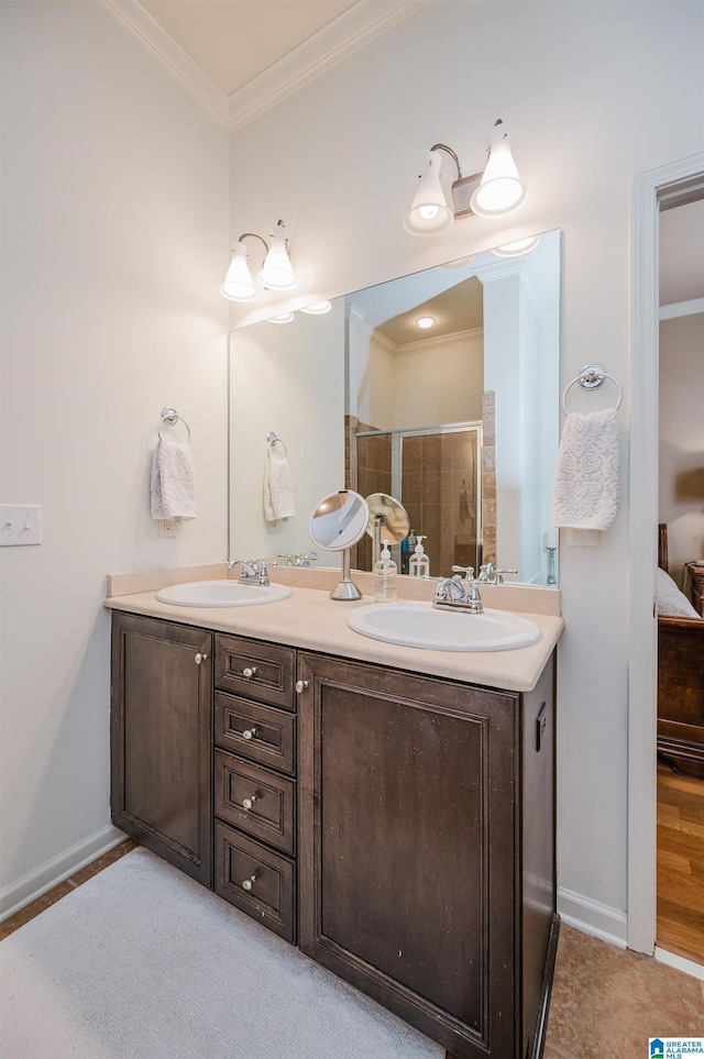 ensuite bathroom with a sink, double vanity, connected bathroom, and crown molding