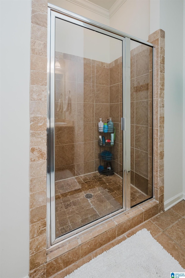 full bathroom with a shower stall, ornamental molding, and tile patterned flooring